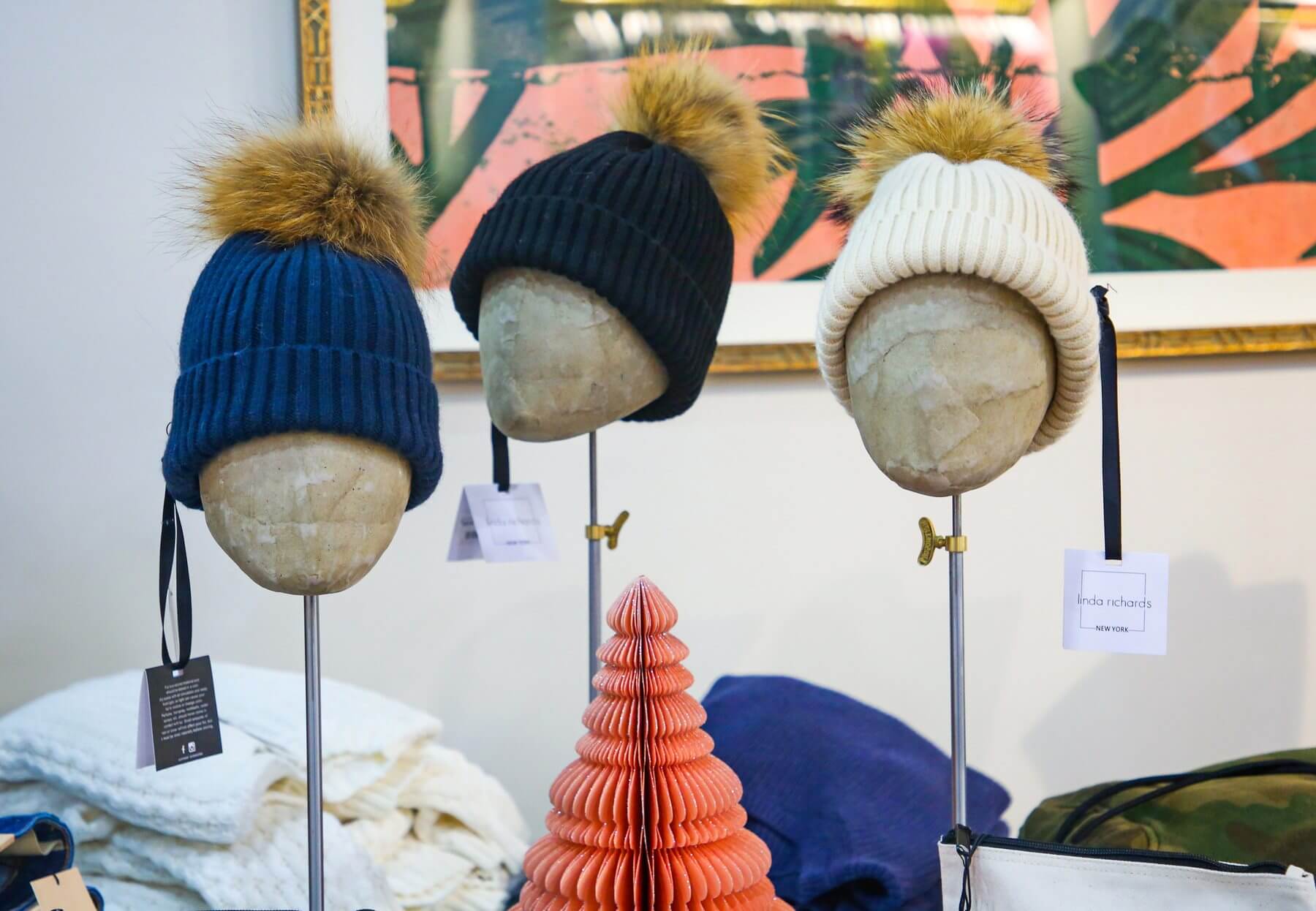 Fuzzy-topped beanies at Duet, a Nashville women's boutique