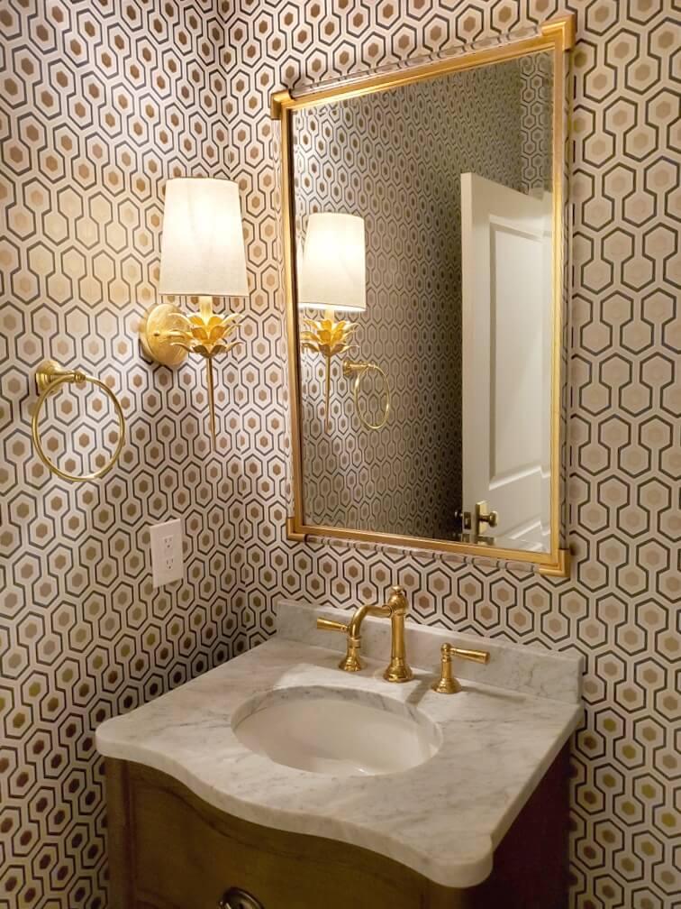 Bathroom with fancy wallpaper with gold accents