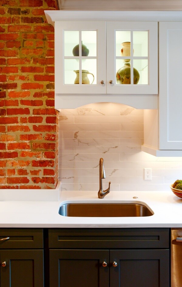 White kitchen with brick accent