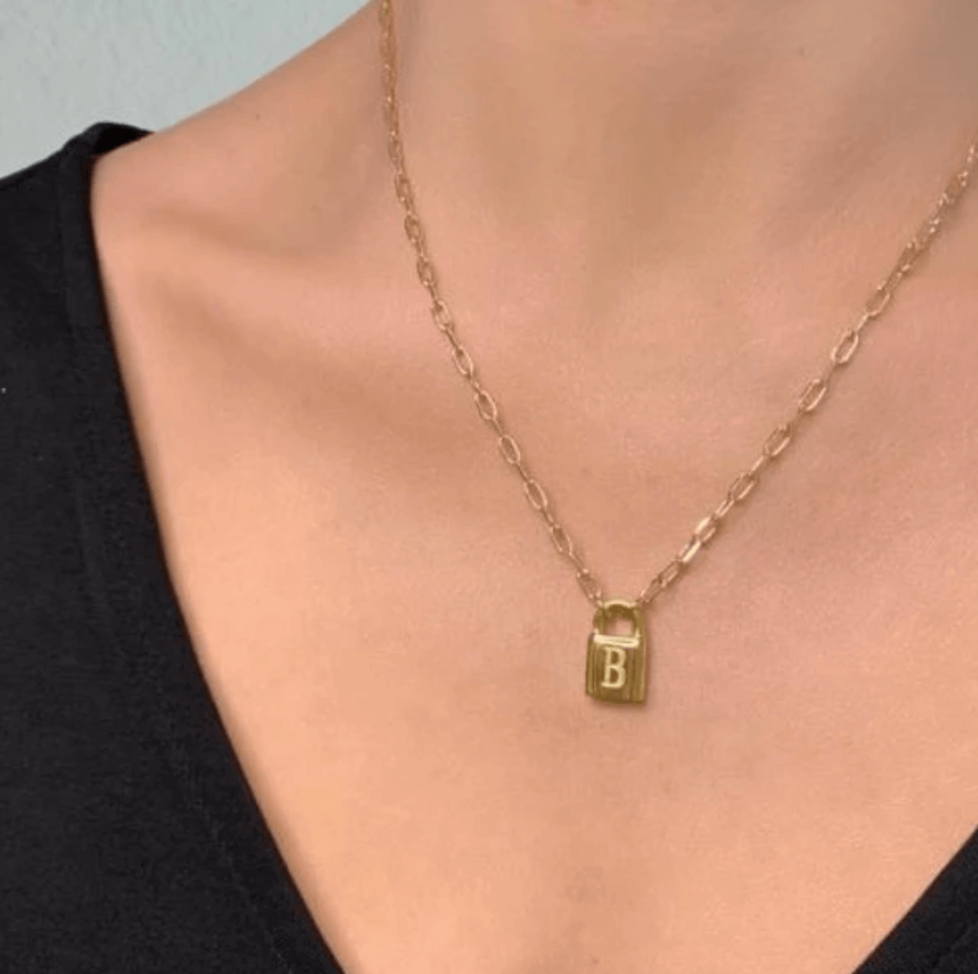 Initial lock necklace, $44.50, Soca Clothing | Image: Soca Clothing Initial lock necklace from Soca Clothing
