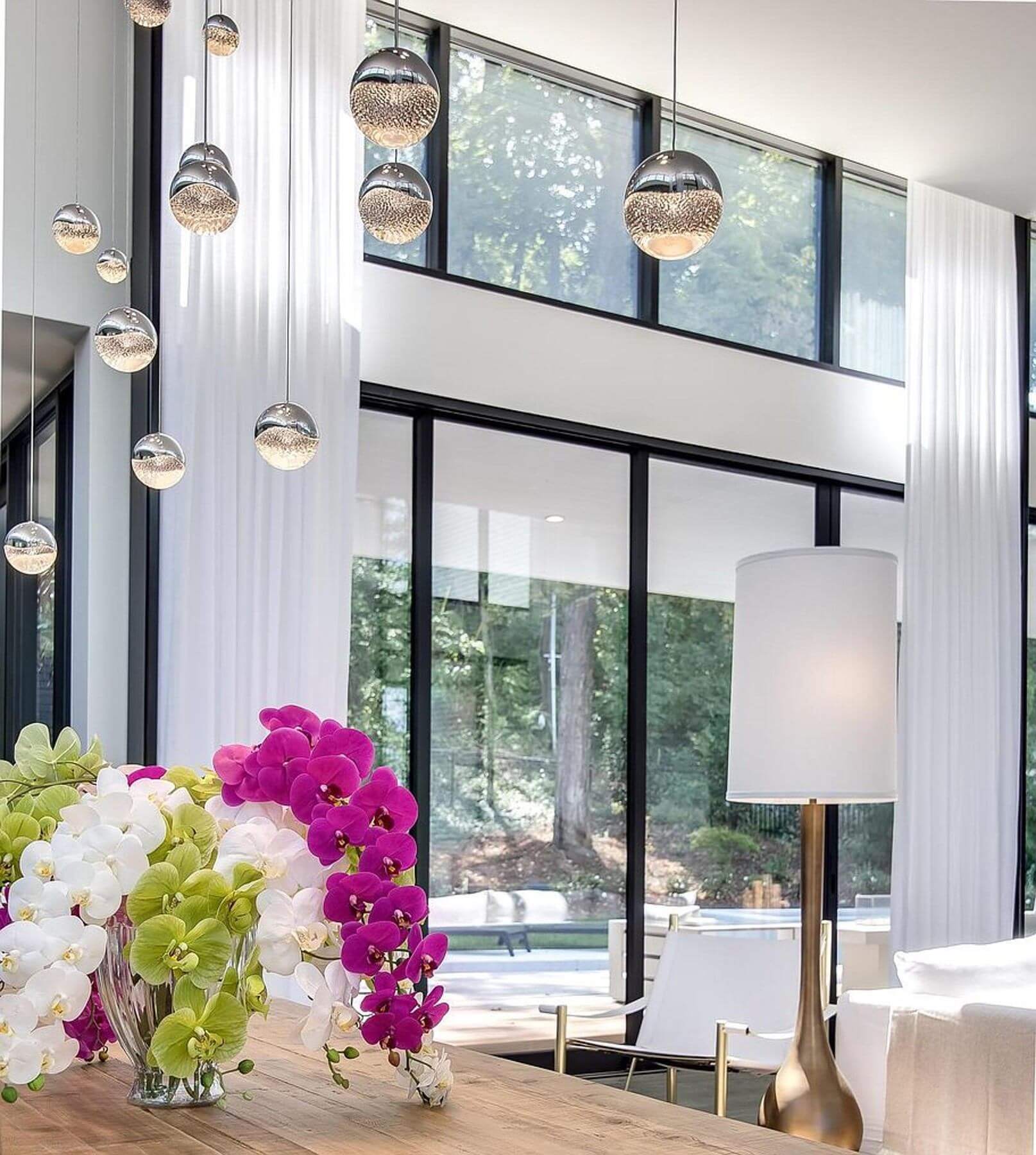 Contemporary black-and-white home features with brightly colored orchids
