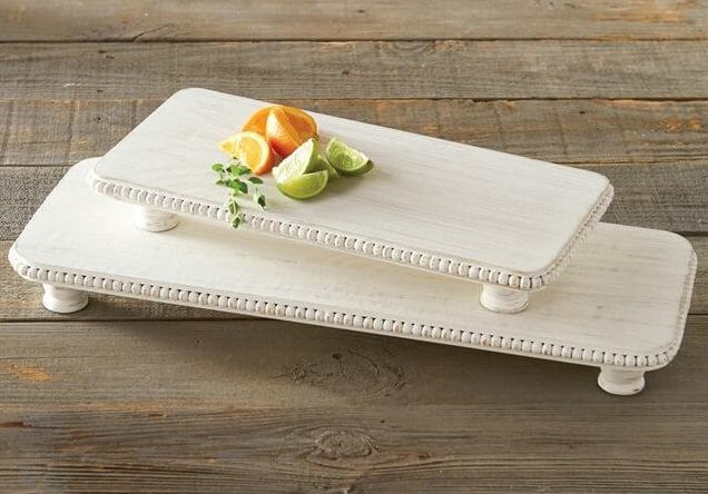 Small board, $38; large board, $42, at Southern Farmhouse | Image: Southern Farmhouse Beaded white serving boards