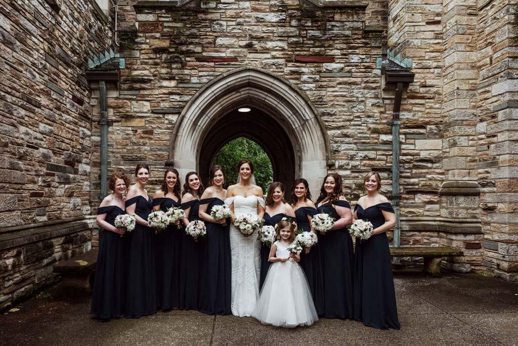 Ellen poses with her picture-perfect bridesmaids and sweet little flower girl on the grounds of Scarritt Bennett. bride with bridesmaids and flower girl
