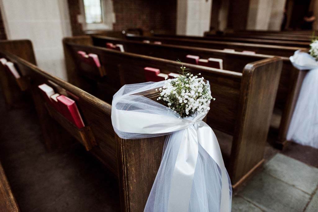 The couple went for a more minimalistic floral aesthetic for the ceremony. “Scarritt Bennett is such a beautiful space, we felt like we didn’t need to do too much. We just did baby’s breath around the pews and then some candles and stuff at the altar.” Baby's breath lines the pews at Scarritt Bennett
