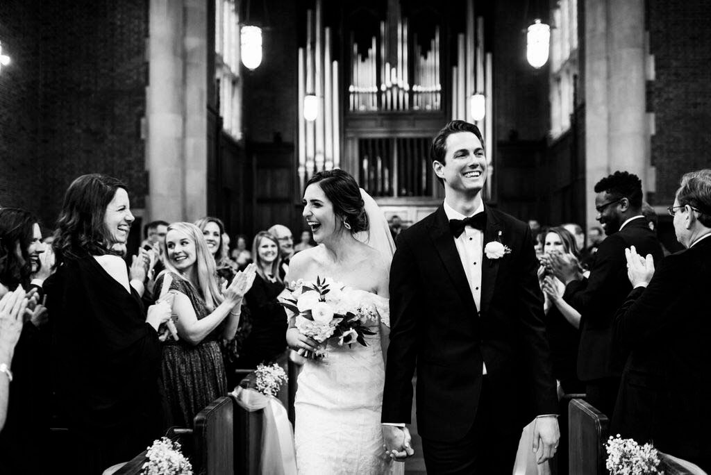 Choosing locations for the ceremony and reception was a relatively easy decision for the couple. “We did the ceremony at Scarritt Bennett, which was a bucket list for me. And with Matt being an architect — once he saw the space, it was like, if there’s any way to make it work …” bride and groom walk up the aisle at chapel
