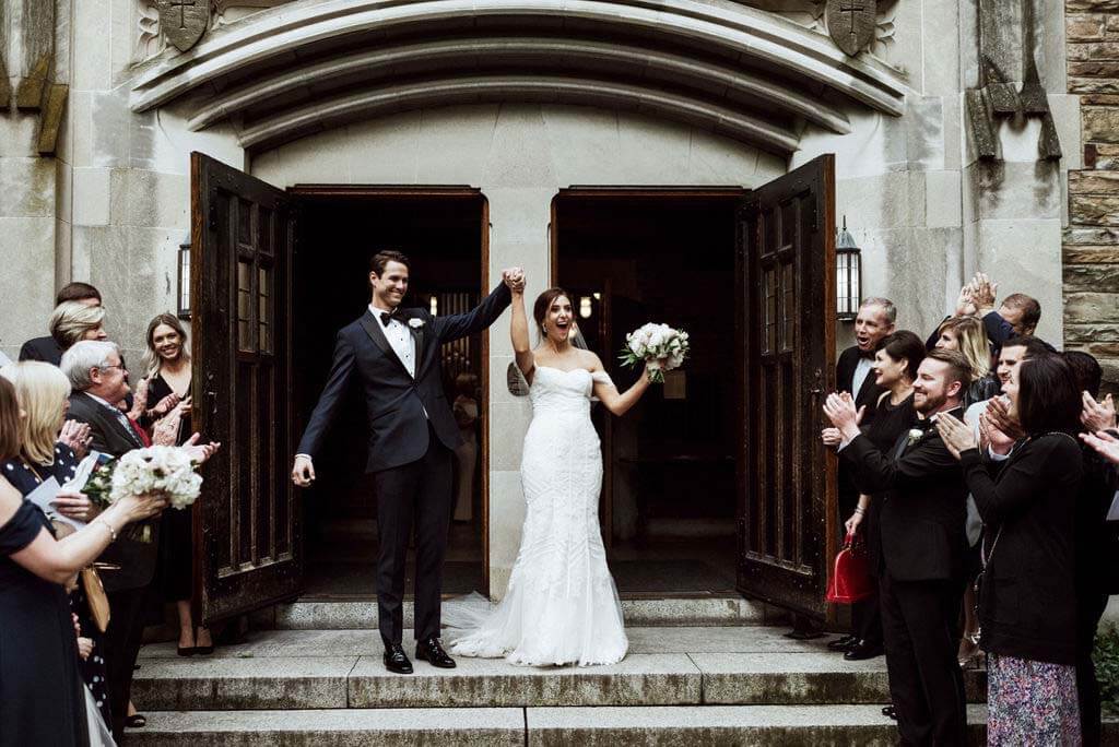 It's official. Congratulations to you, Mr. and Mrs. Boker! bride and groom cheering outside chapel