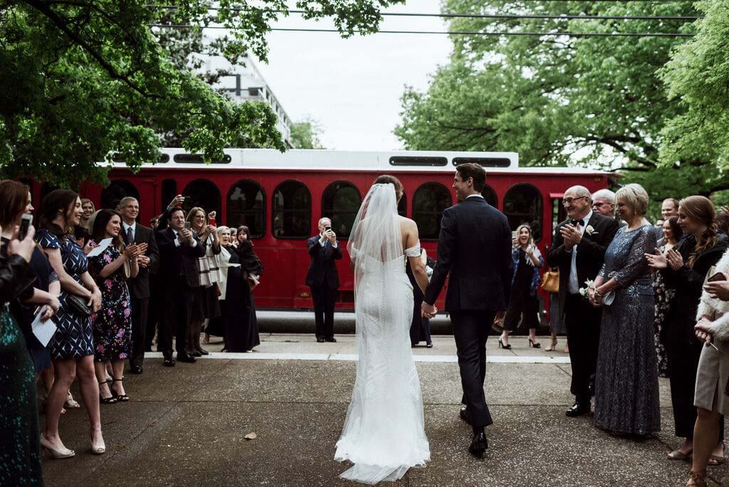 This trolley, from FADDS Nashville Party Bus, made for a grand ceremony exit. bride and groom head to trolley after ceremony