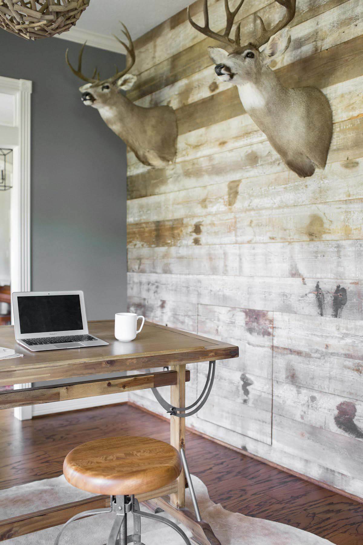 Study with desk nook and hunting trophies in Houston farmhouse renovation