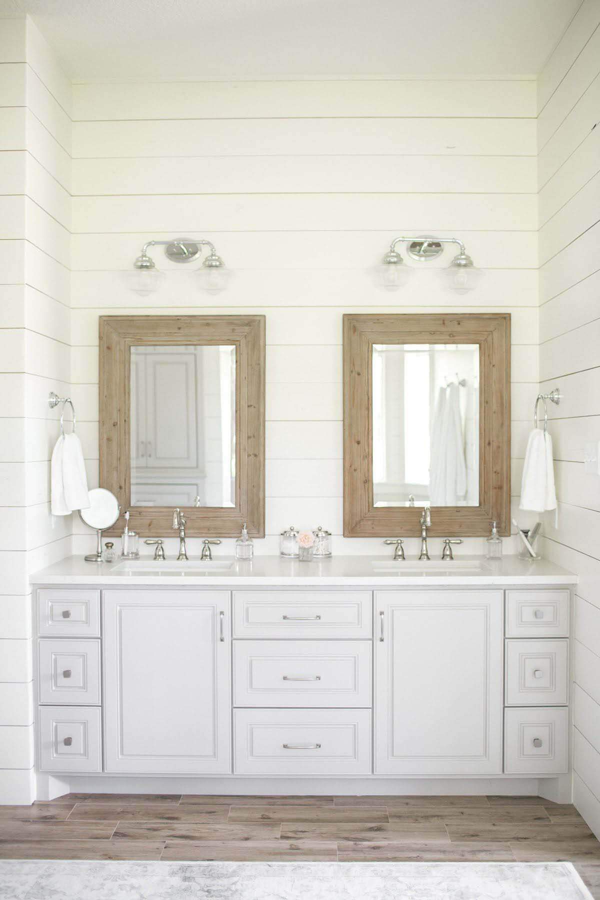 Bathroom vanity with mirrors and gray cabinetry
