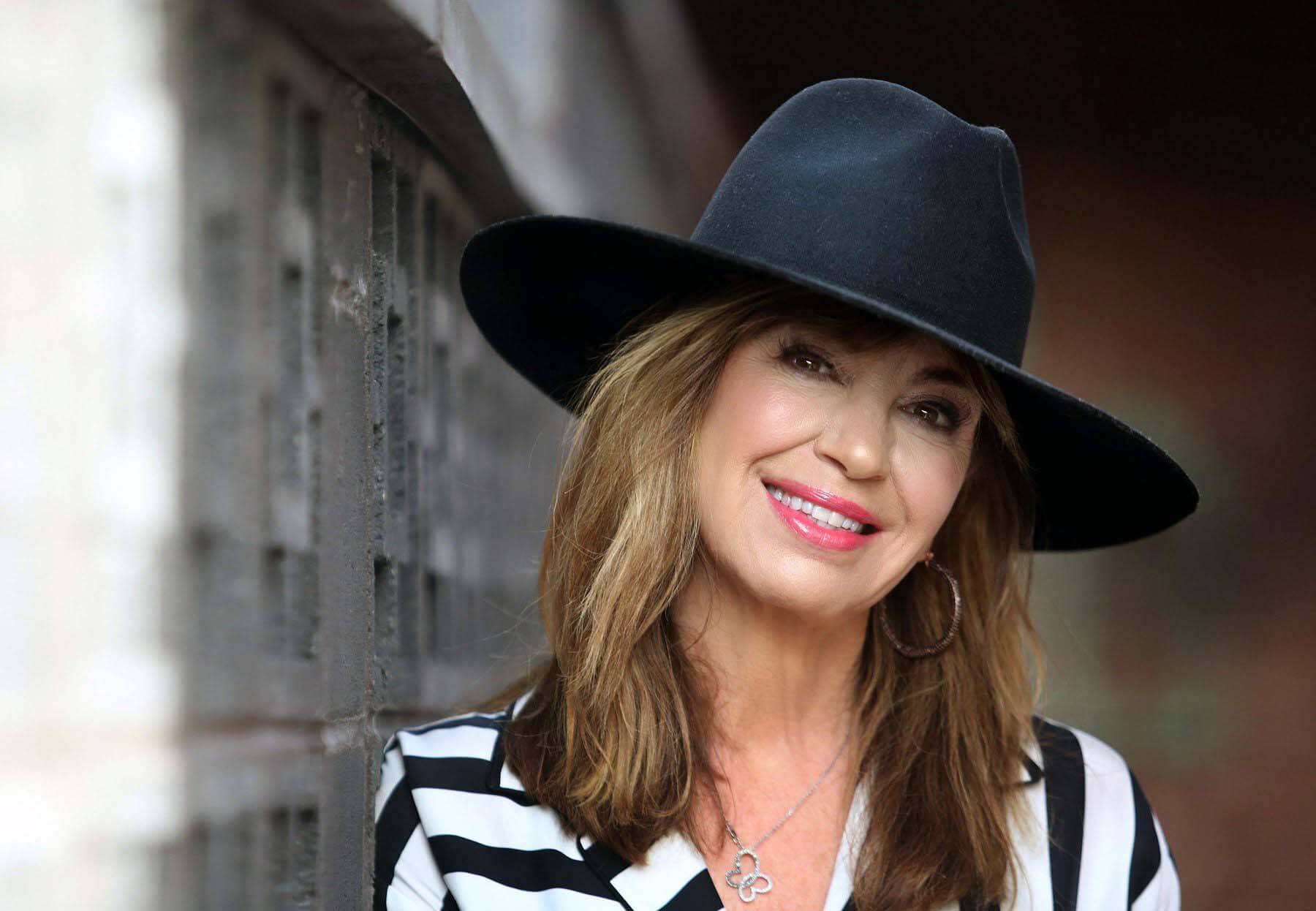 Amy in black-and-white striped blouse and black hat