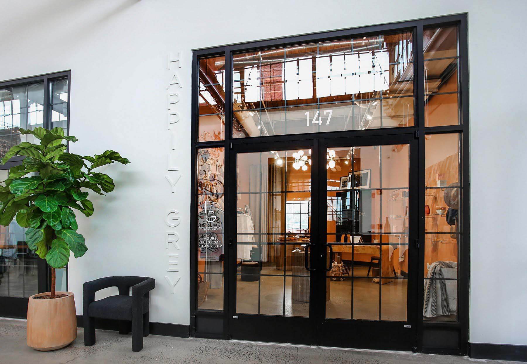 The Happily Grey storefront, with its subtle signage, offers a glimpse into what we can expect inside. Storefront for Happily Grey