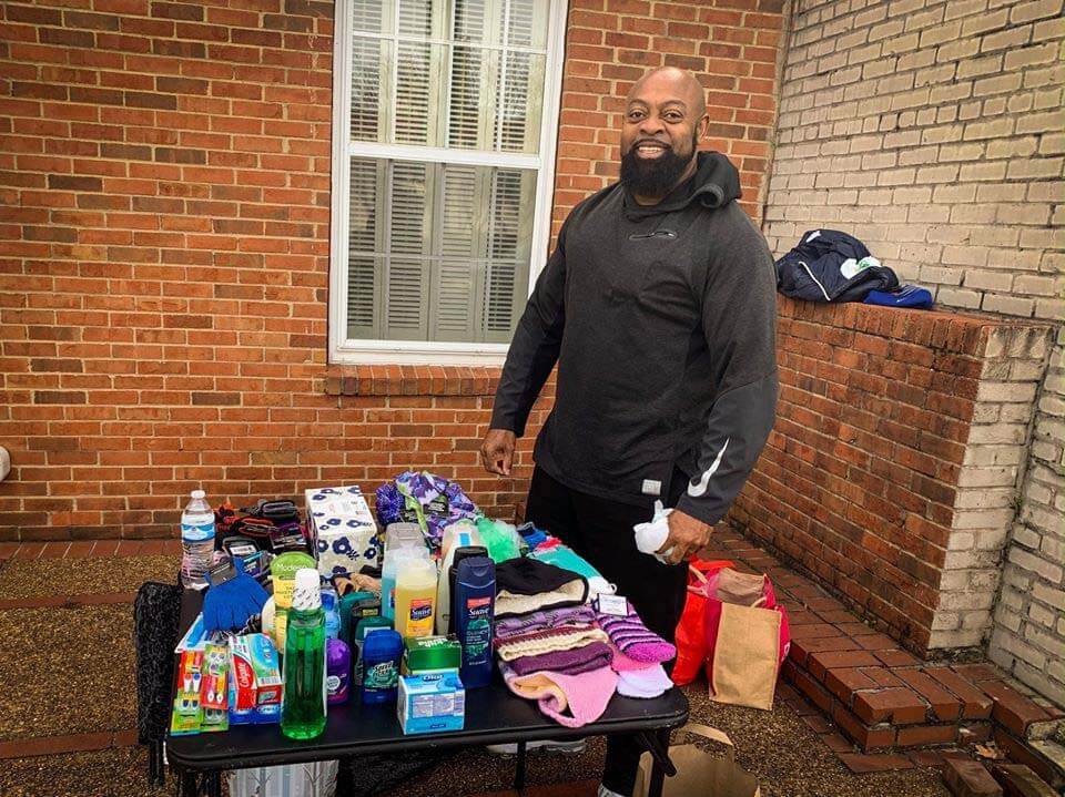 We often take everyday beauty necessities for granted. Here is a volunteer giving out every day necessities. Image: Second Line