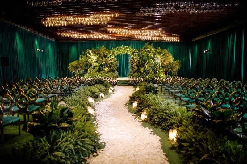 greenery with white petal path leading to altar