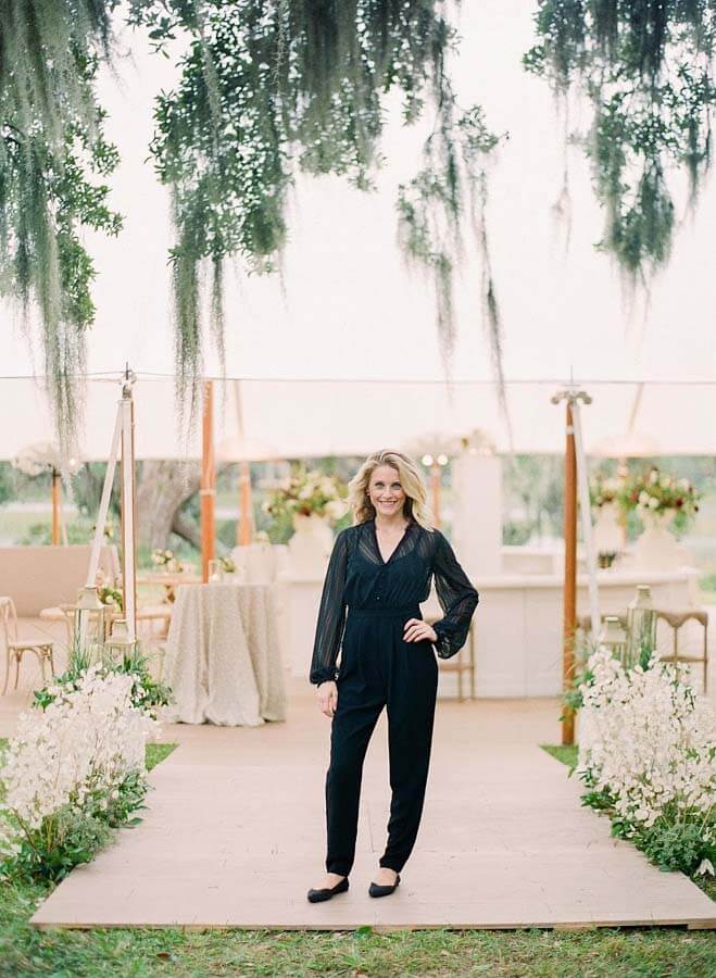 Reagan Kerr poses in front of a tent at one of the weddings she has planned