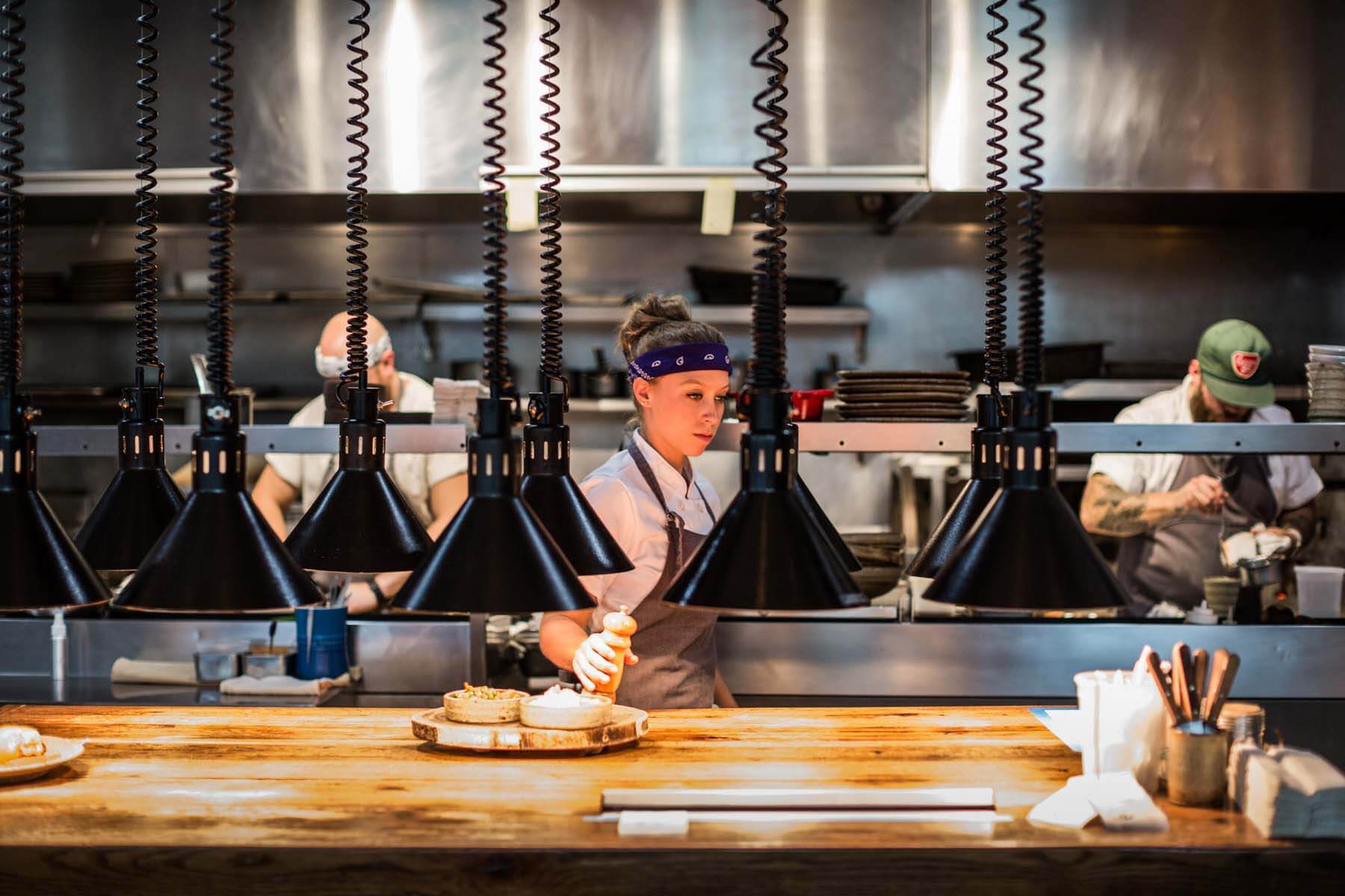 Katie Coss working in Husk's kitchen