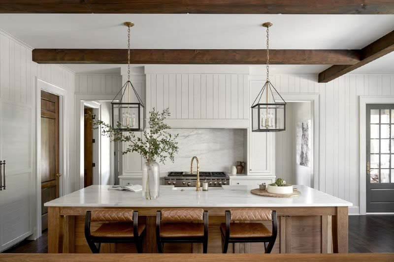 "We wanted the kitchen to be very simple," says Rachel. She chose a slab backsplash that matches the countertops and island to avoid distraction. "I mean, you see the kitchen right when you walk in," she adds, "so, I didn't want it to have any elements that were so strong that they took away from the whole room." Pfeffer Torode kitchen on Tyne Blvd