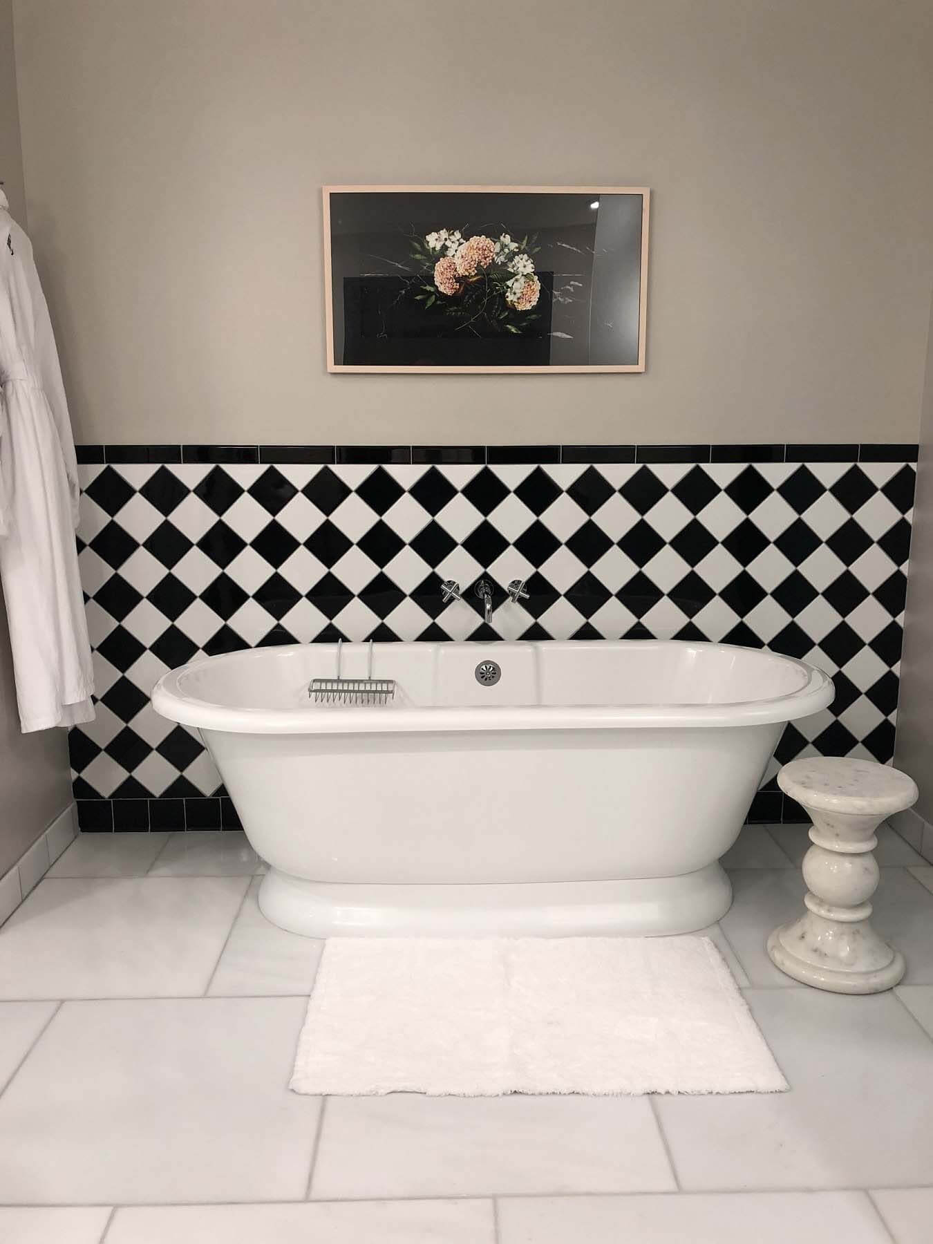 Black and white bathroom with tub at The Candler