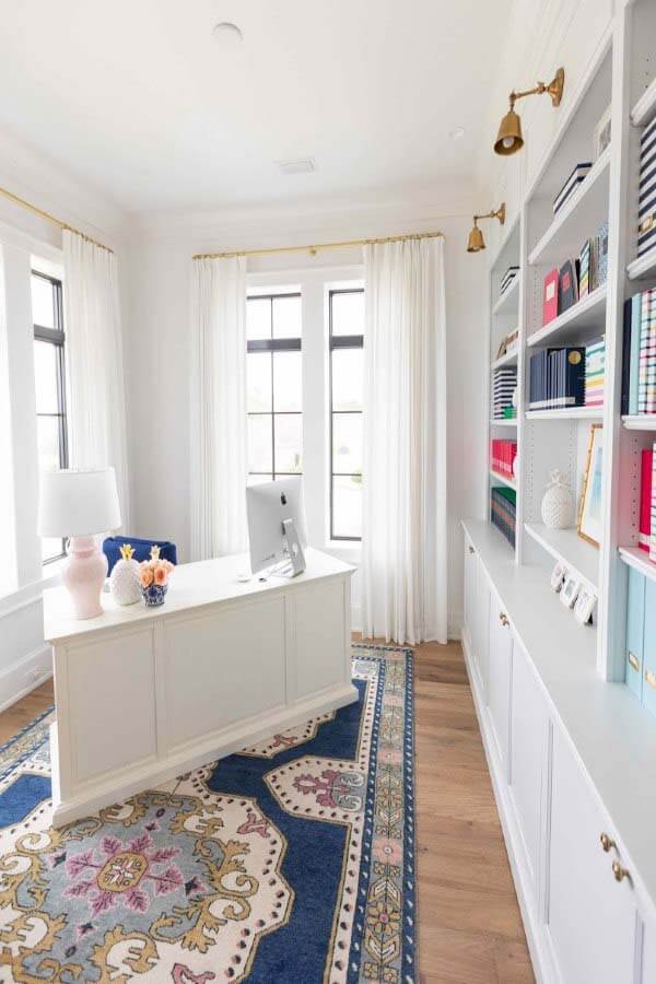 All-white desk in the home office of Emily Ley