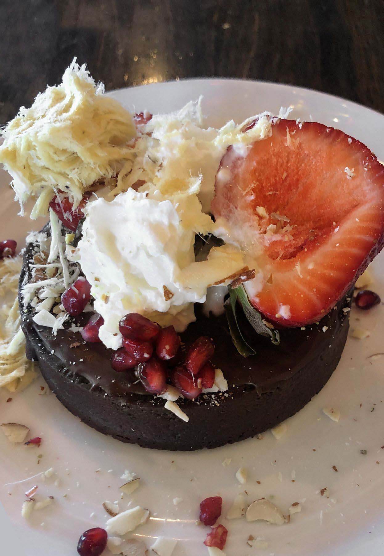 Chaatable tart with strawberries, whipped cream and pomegranates