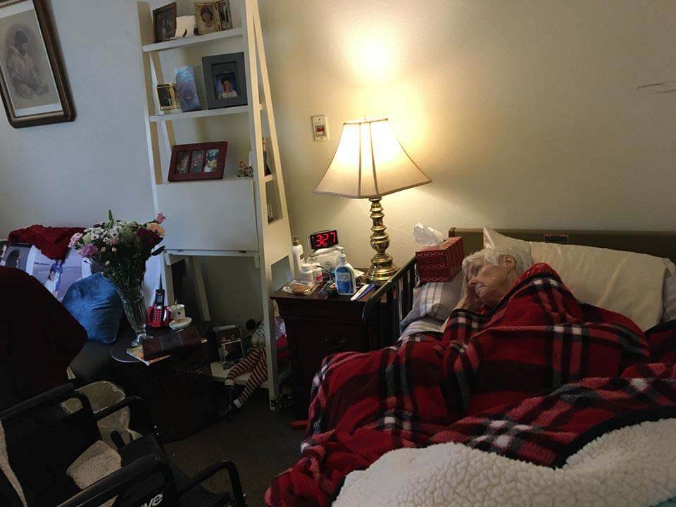 Moe's mom in hospice with Trader Joe's flowers