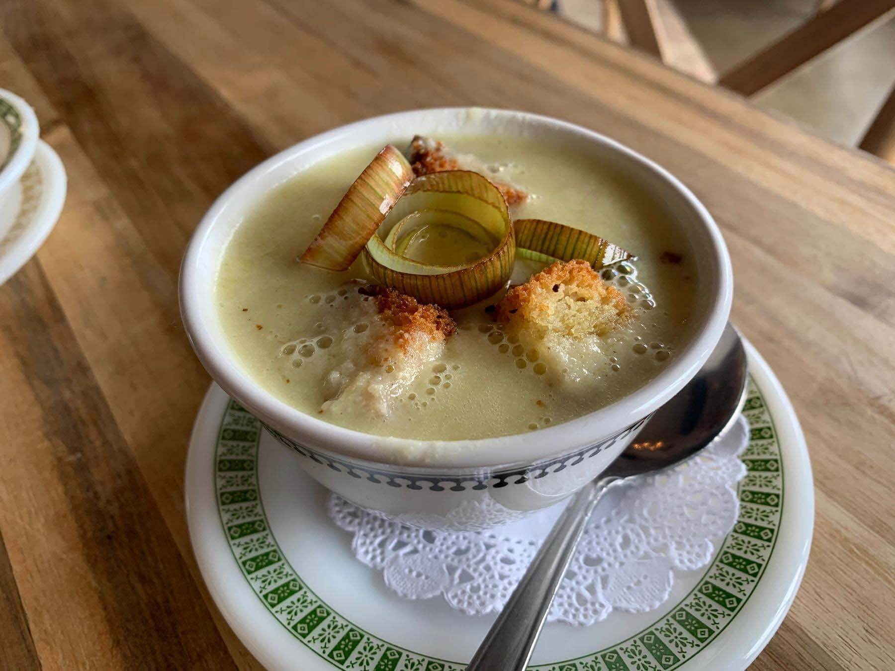 The popular buttermilk cornbread soup topped with fried leeks and cornbread croutons at Bobby Carl’s Table. Image: Lauren Helmer Buttermilk cornbread soup from Bobby Carl's Table — a new Mountain Brook restaurant