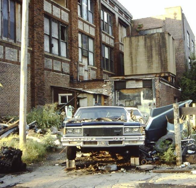 old car and trash heap outside Marathon factory