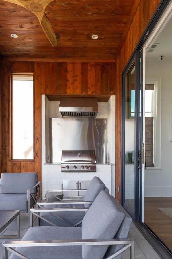 Four season porch with grill and chairs