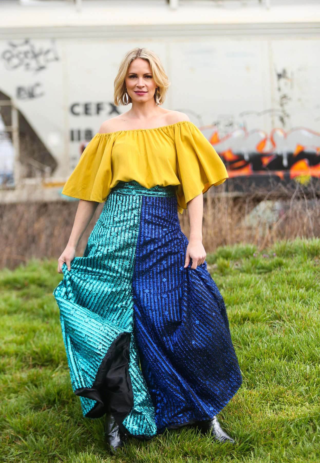Model wearing Ola Mai and Laura Citron ensemble with two-blue pants