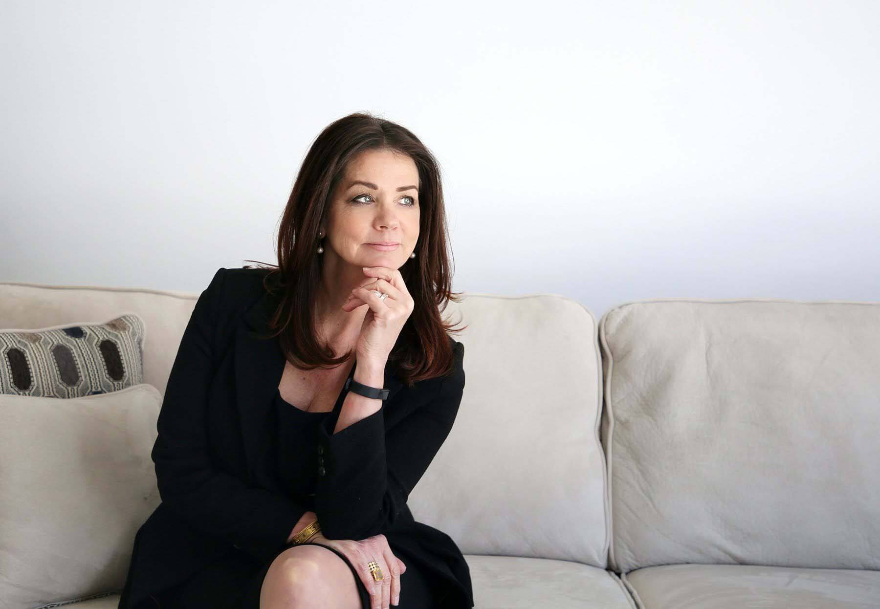 Sherry Deutschmann sitting on couch