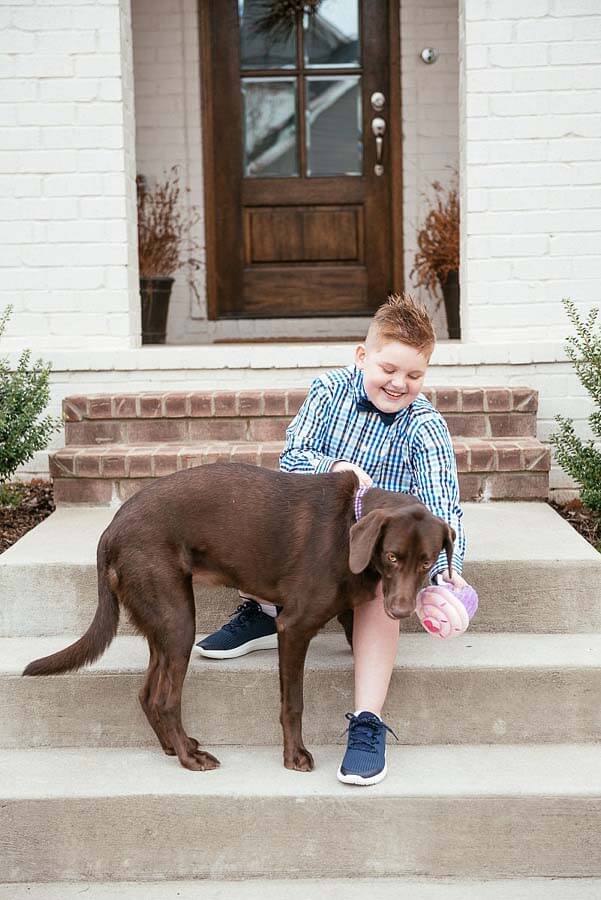 Boy with his dog on front stairs. Image: Tausha Dickinson