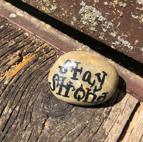 Stay strong message on rock