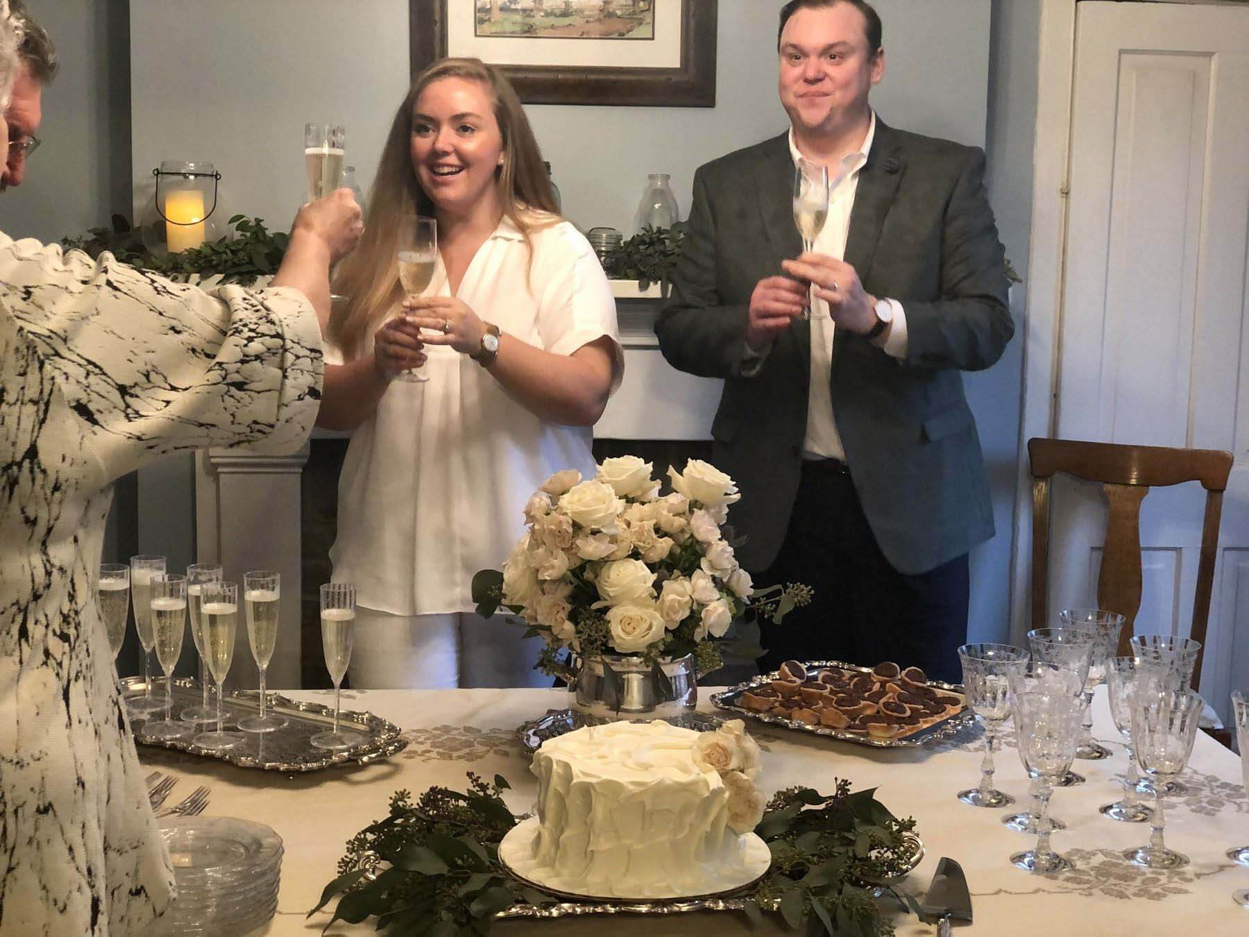 Ann Walker and Daniel listening to toasts