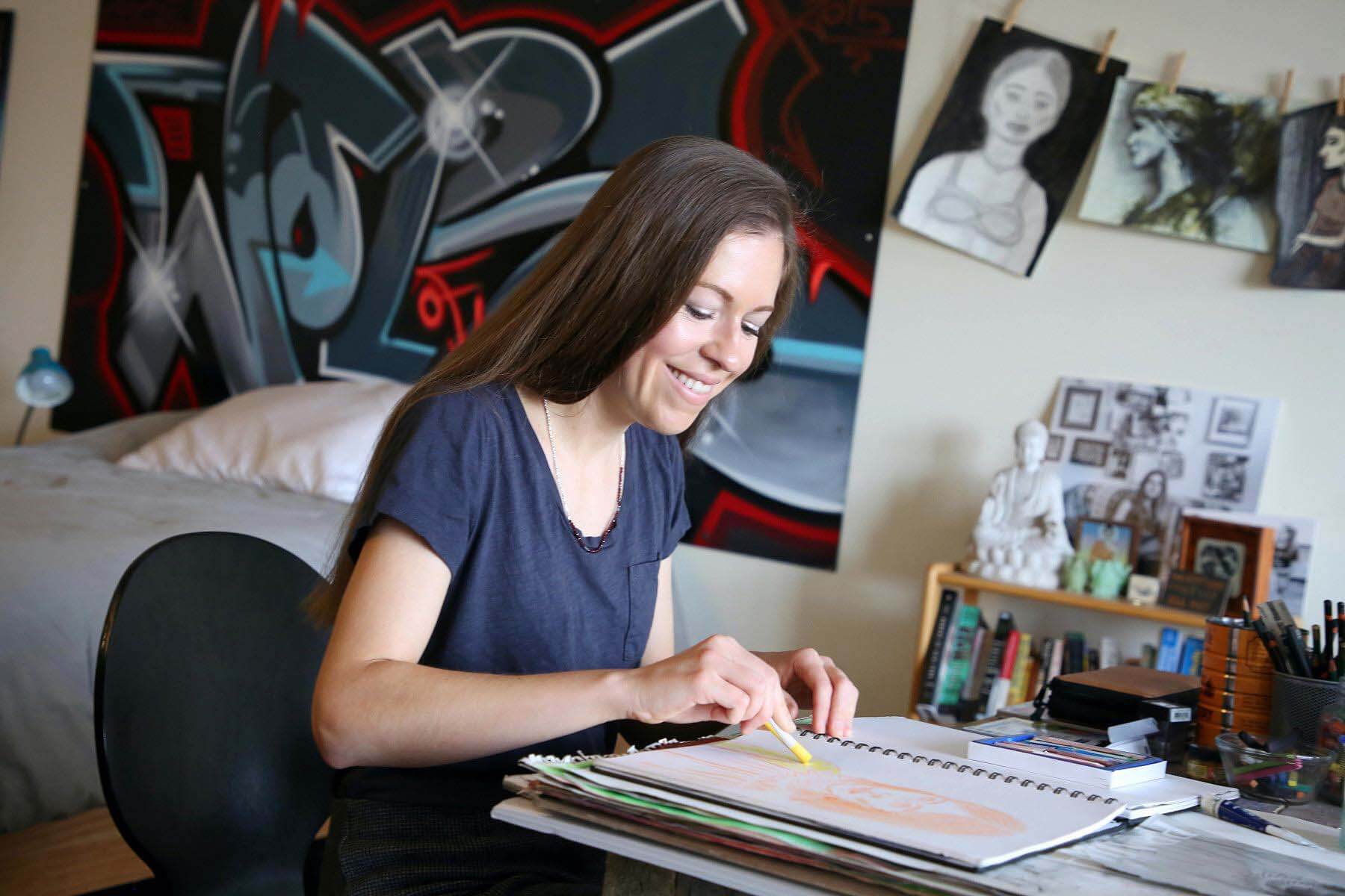 Lily Hansen drawing in her sketch book