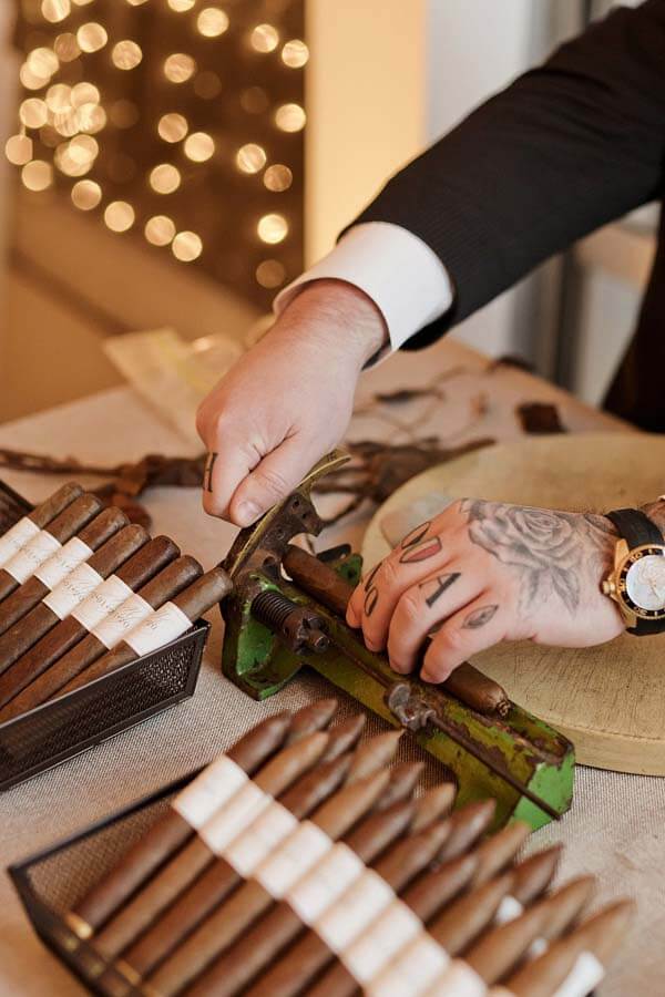 Hand-rolled cigar bar at a winter wonderland wedding | Photographer: Kristyn Hogan