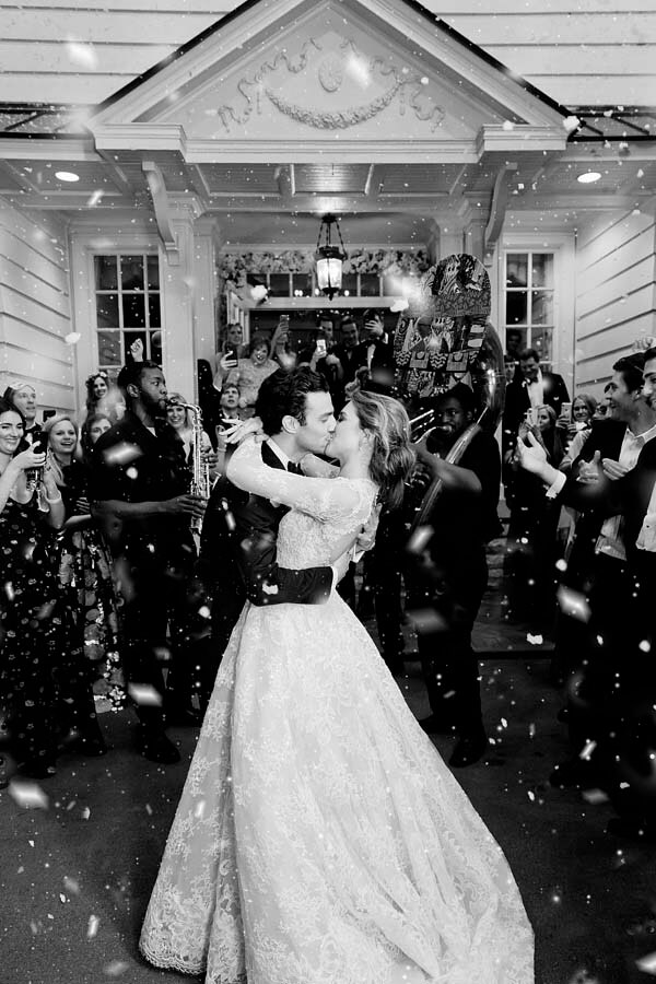 A snowy exit at a winter wonderland wedding Photographer: Kristyn Hogan