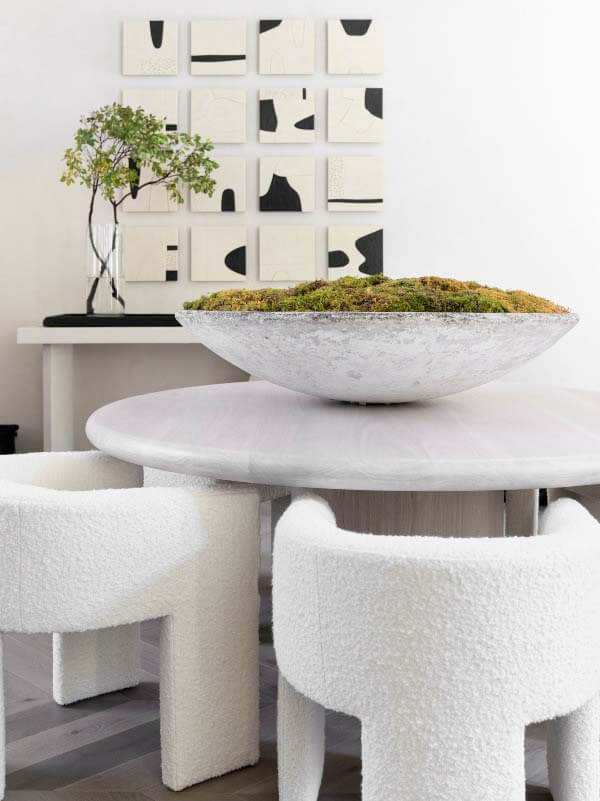 Dining room with round table by Wolf Design Group