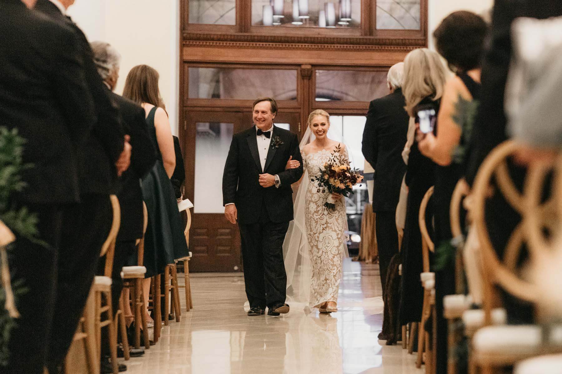 The bride and her dad walking down the aisle