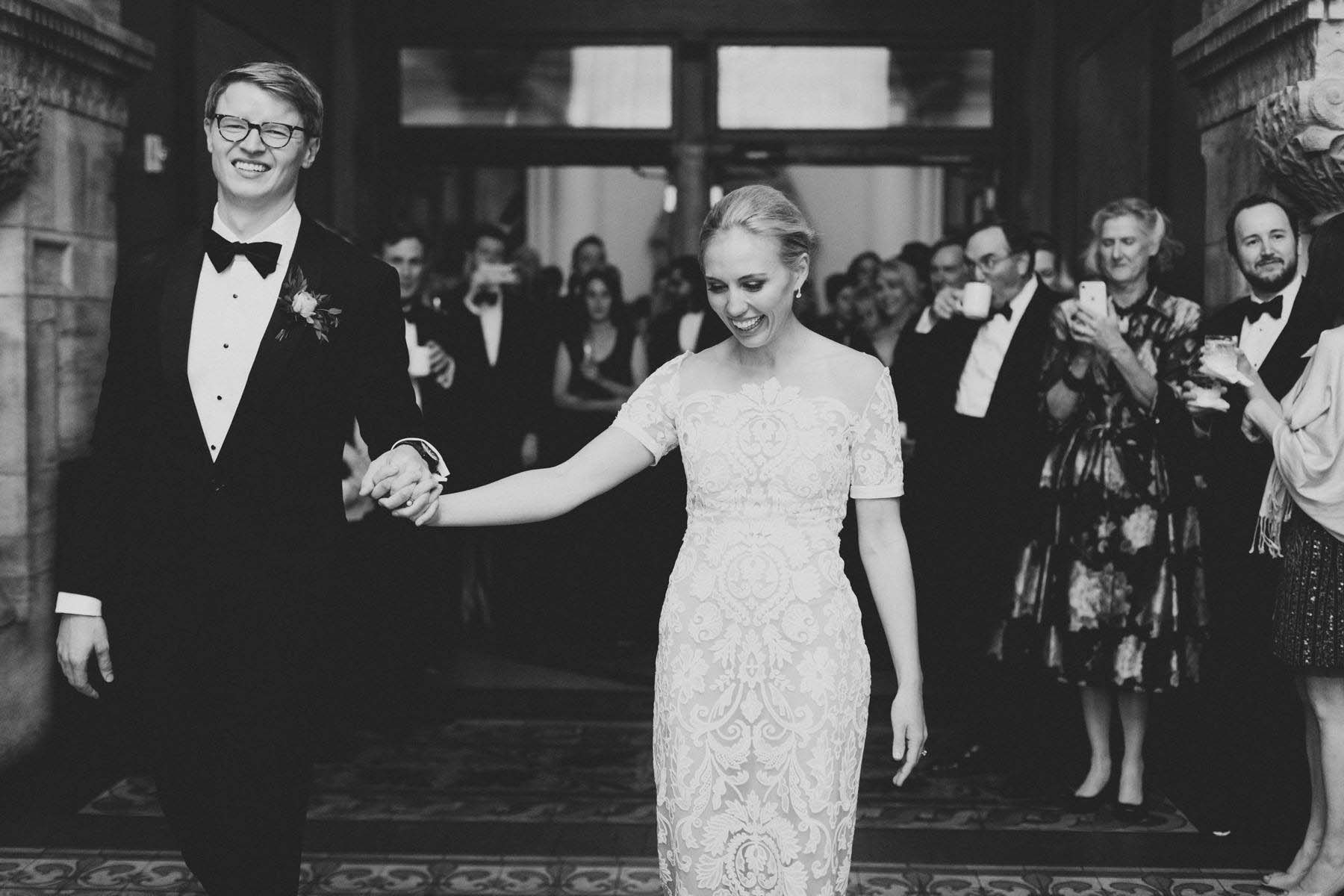 Bride and groom entering reception