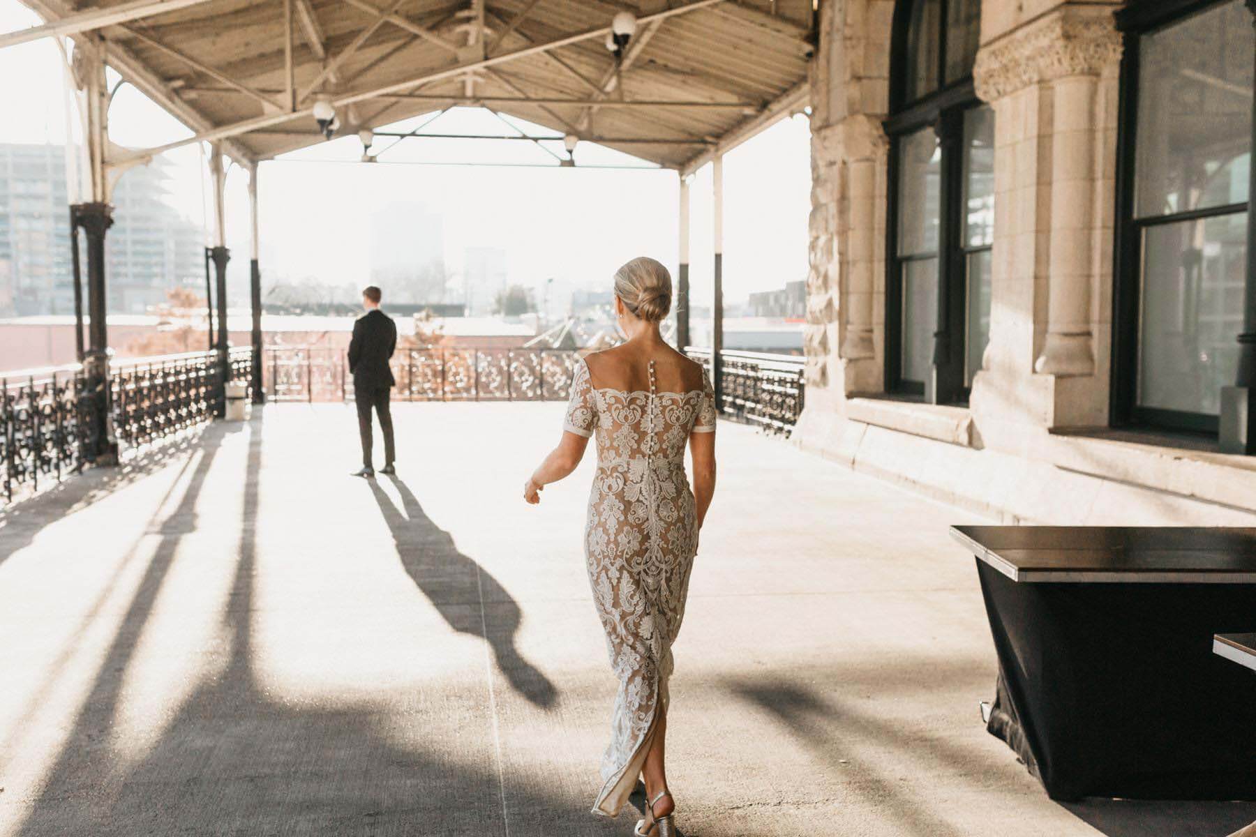 The bride and groom do first looks on the veranda before their autumn wedding