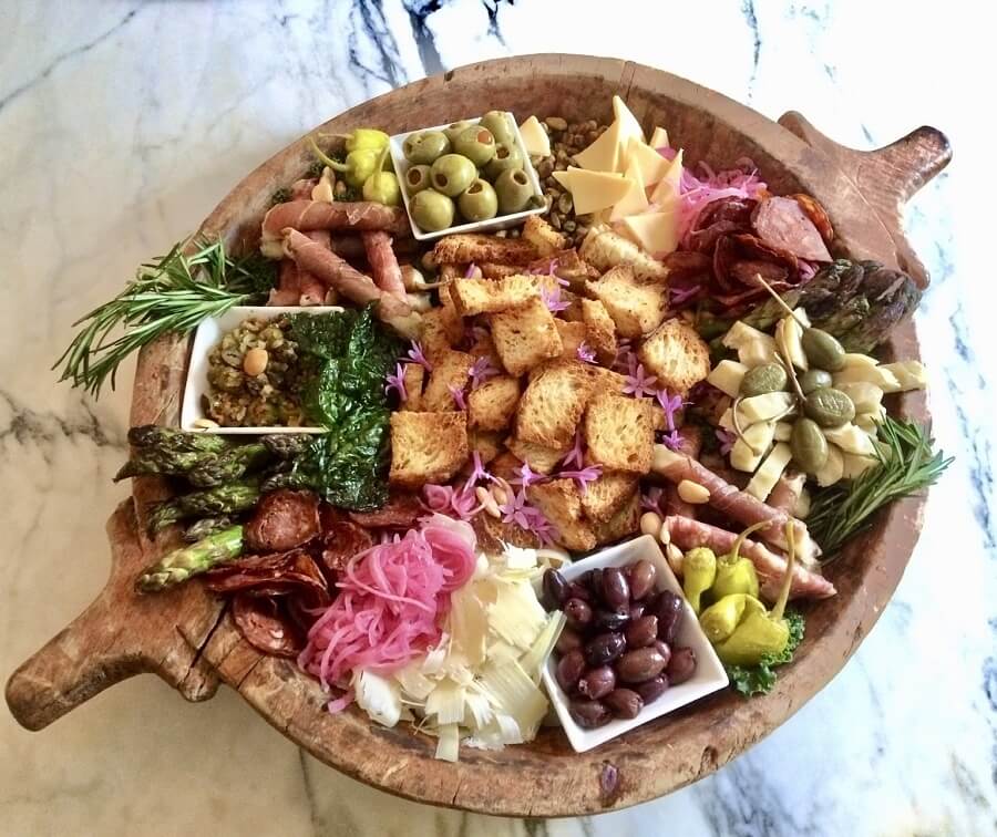 A perfect charcuterie board by caterer Johnny Haffner, in a vintage wooden bowl