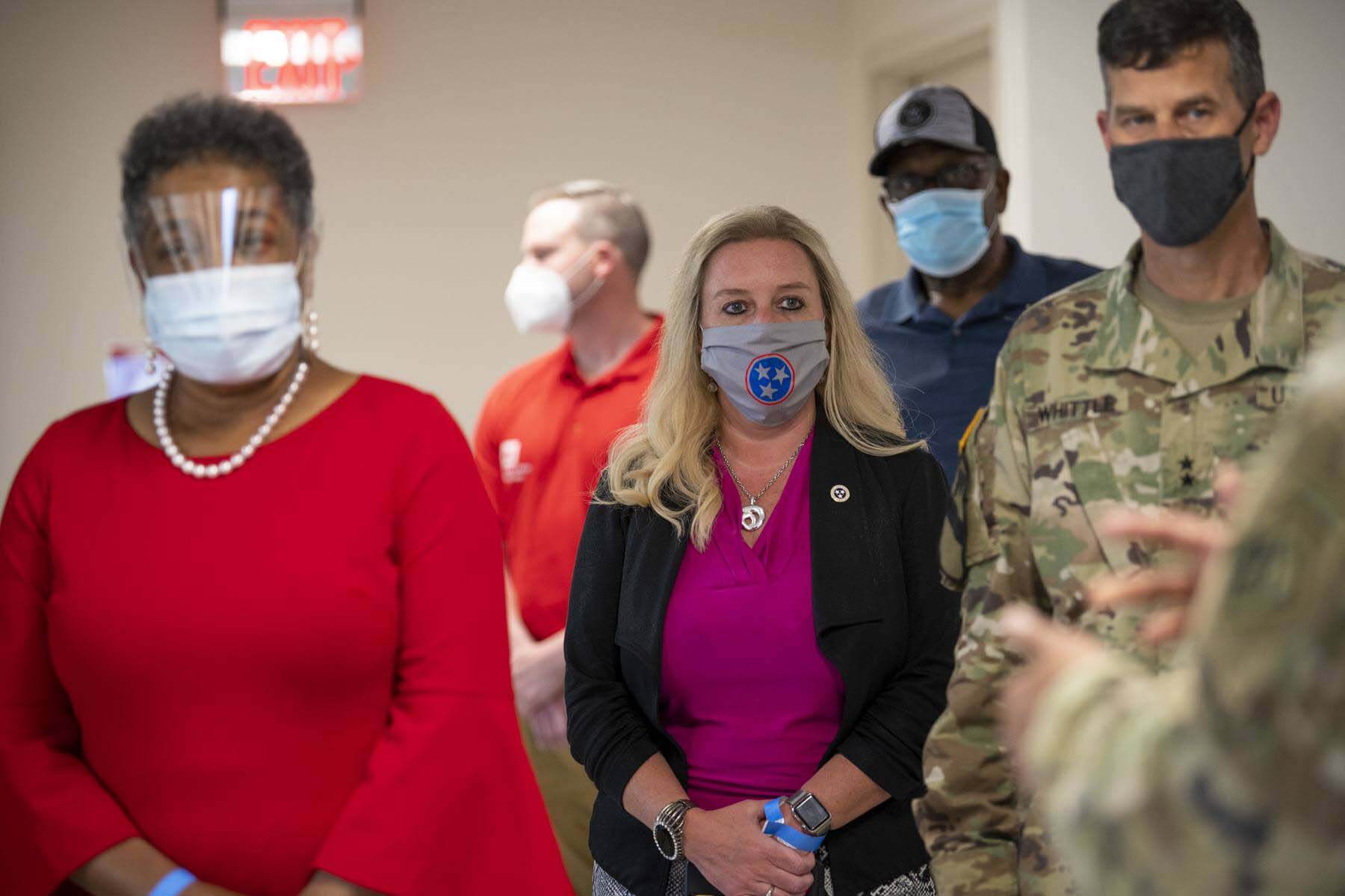 Dr. Piercey walking with healthcare professionals wearing masks