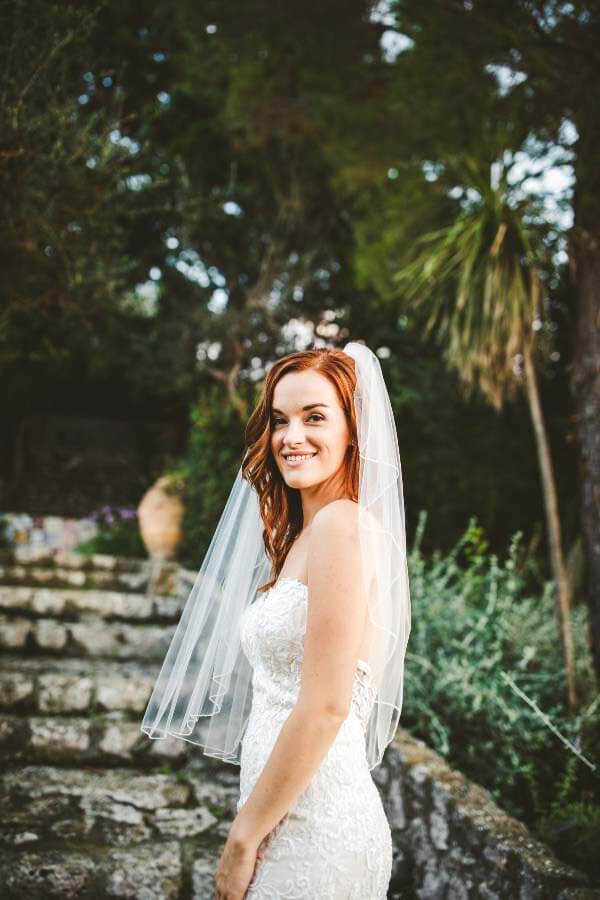 Lacy posing in her wedding dress and veil