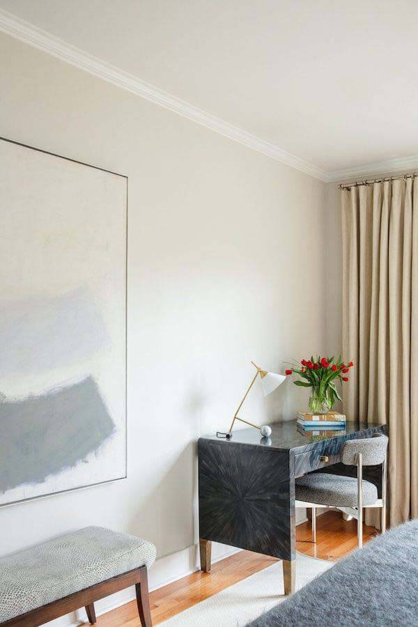 Desk in the corner of home's master bedroom