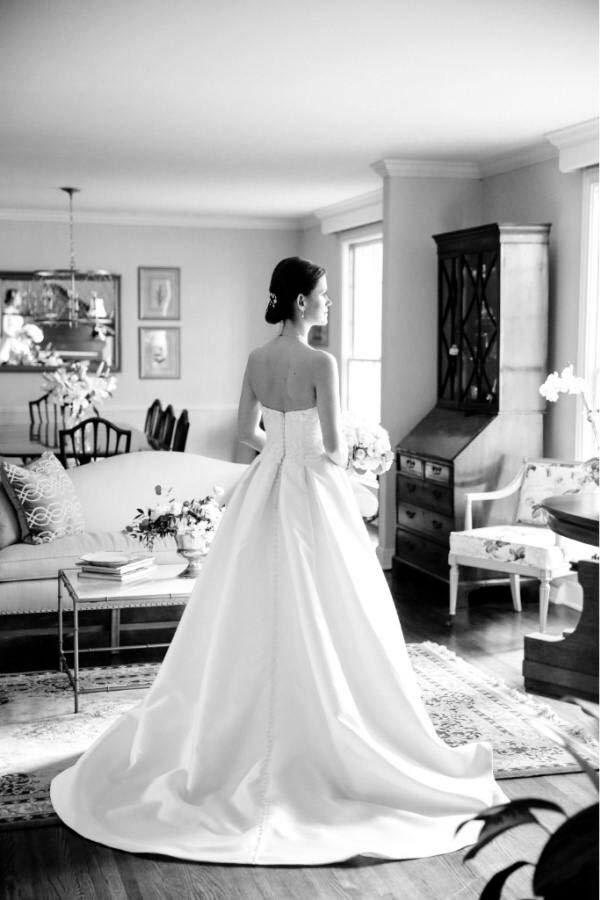 black and white photo of bride in her gown, with her back turned