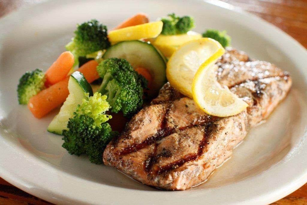 This salmon and veggie plate has all the flavor (and doesn't taste like your typical healthy meal). Image: Huey's Salmon Veggie Plate from Huey's