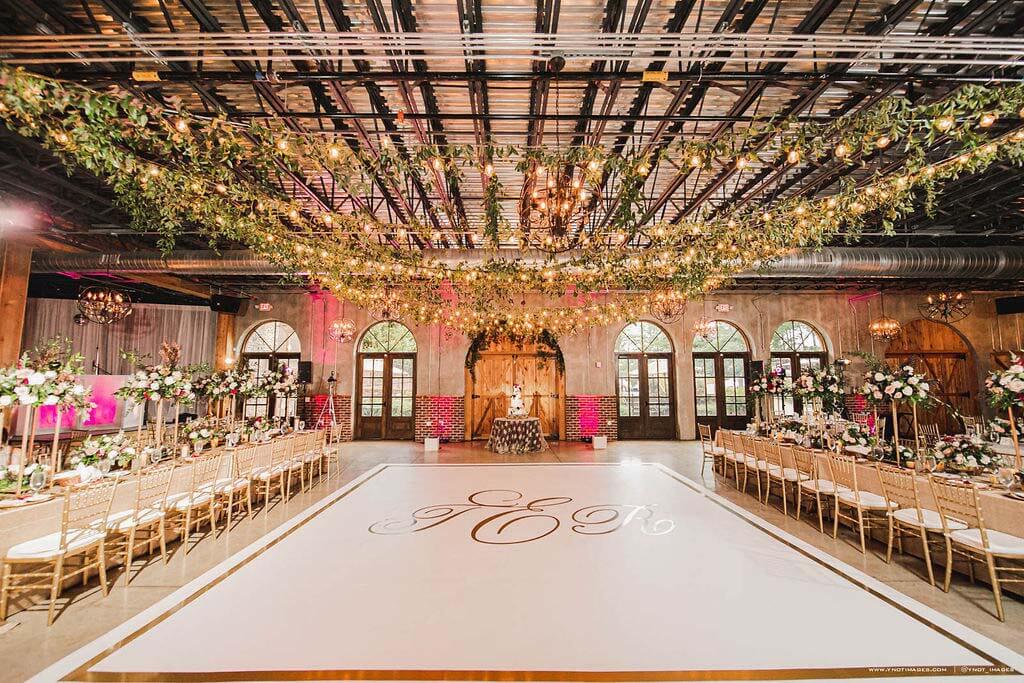 Complete with a dance floor ceiling installation by Design Productions, the stunning reception area celebrates the newlyweds. Reception area with ceiling installation by Design Productions