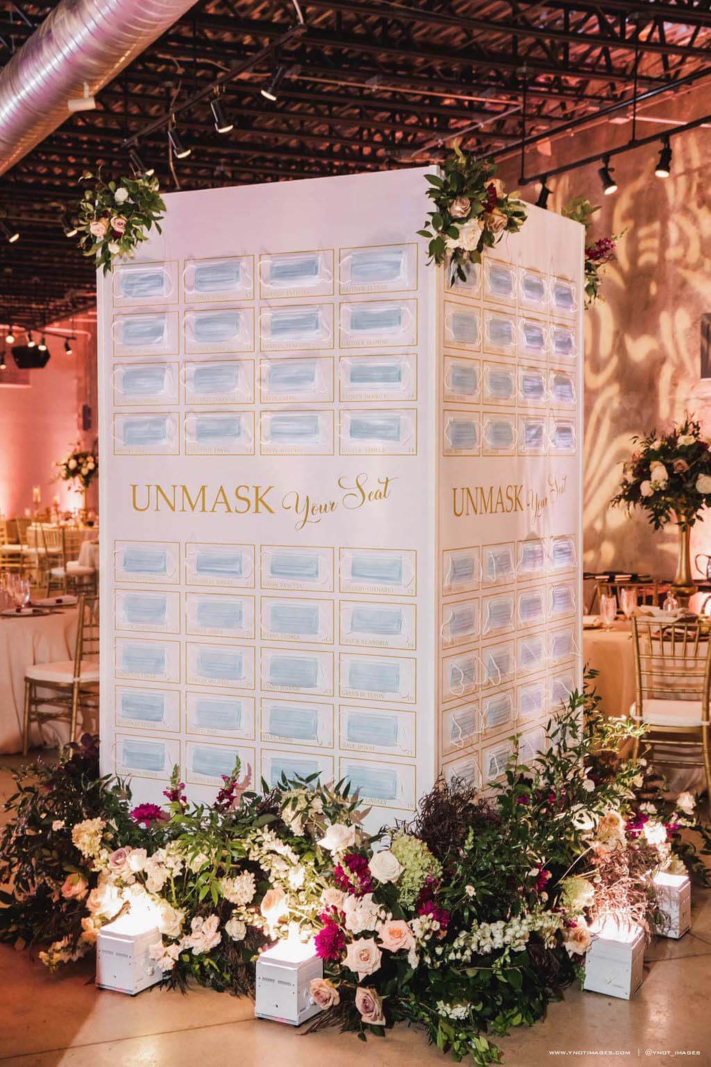 Guests were invited to "unmask" their seat at the reception with this creative seating chart. Creative seating chart with face masks