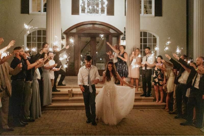 A sparkler send-off closes out the evening; a magical ending to a magical day. Bride and groom exit their French country wedding amid sparklers