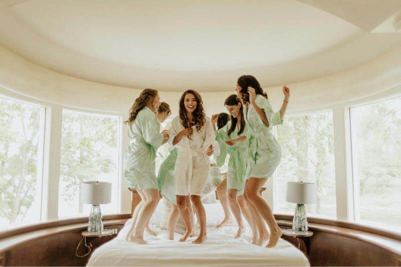 What's getting ready without a little fun with your bridesmaids? Jordan and her crew take a break from getting gussied up to indulge in a bit of playtime. Jordan and her bridesmaids jumping on the bed