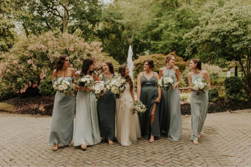 "For the dresses, I wanted it to be pretty natural — no crazy colors — so the bridesmaids' dresses are different shades of gray-ish blue," says Jordan. "One was twilight, for example, and one was dusty blue. It was sort of an ombré deal, going from darker to lighter shades." French country garden themed wedding with bridesmaids in blue